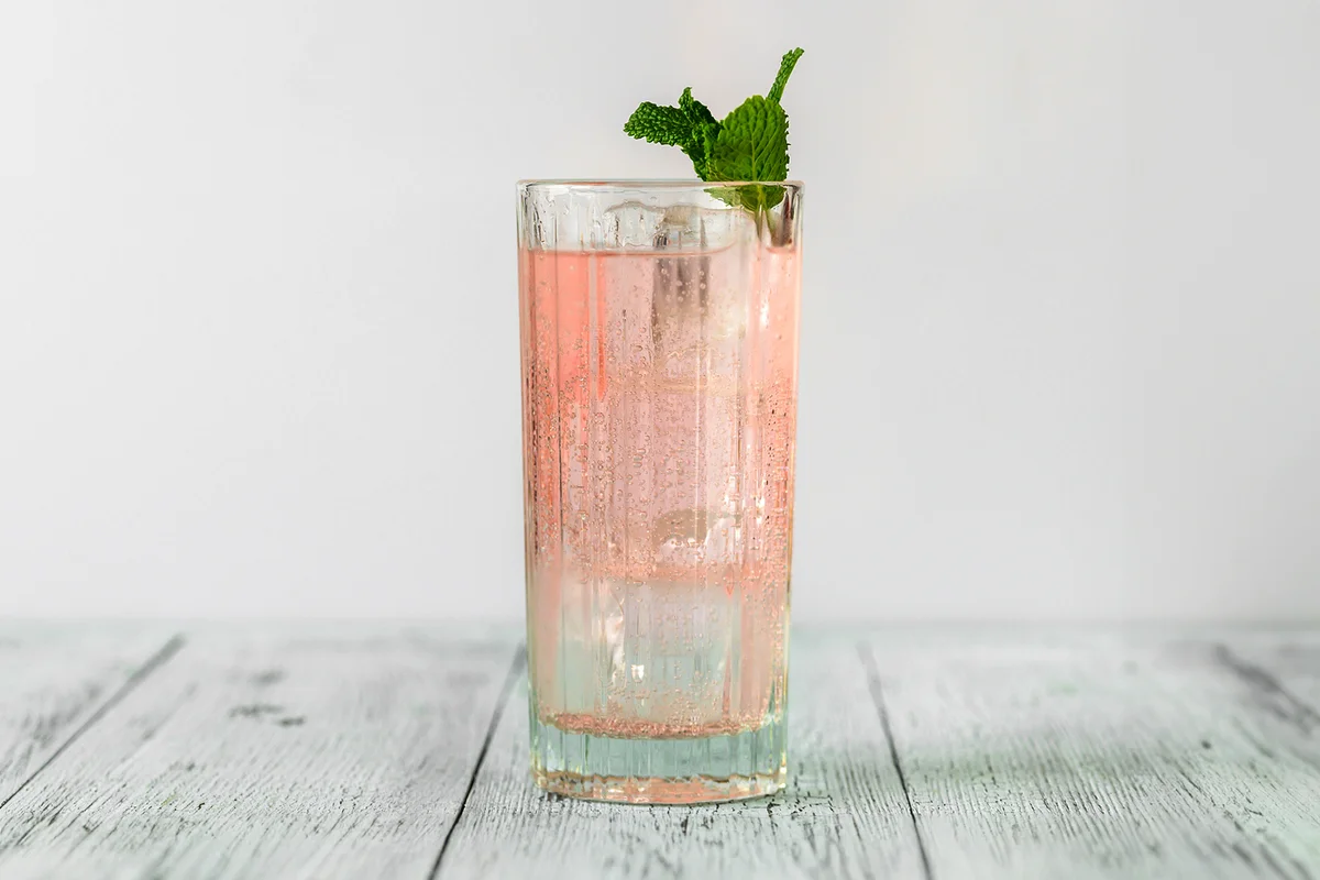 Glass of pink gin and tonic cocktail