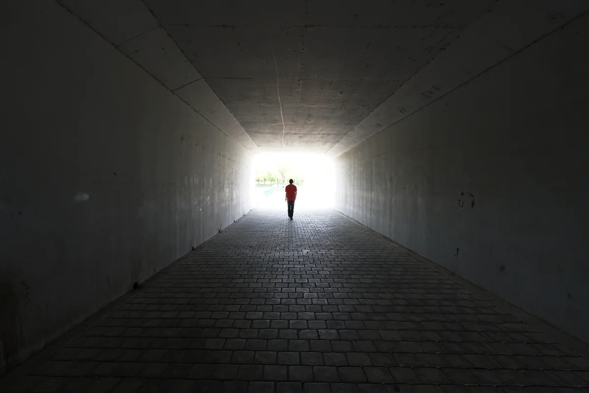 person walking in a tunnel