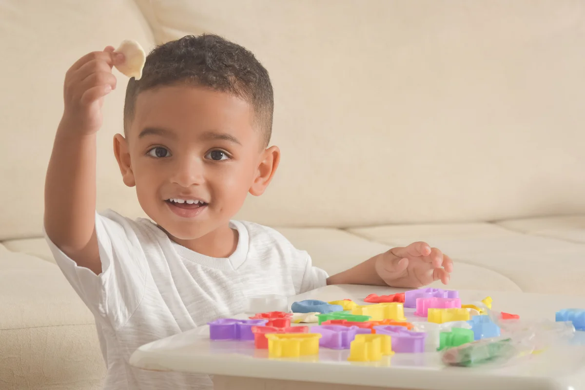 boy playing with clay