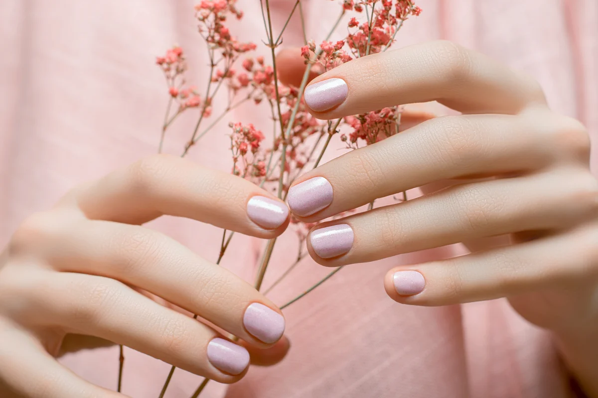 Female hands with pink nail design