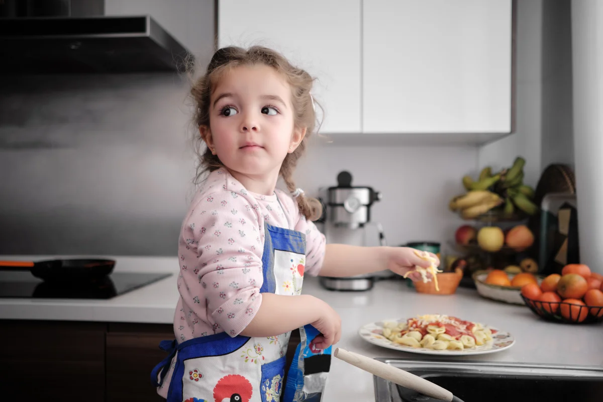 child helping in the kitchen