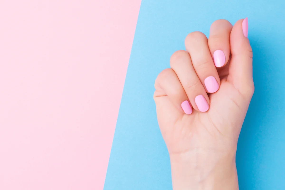 Woman's hand with light pink nails