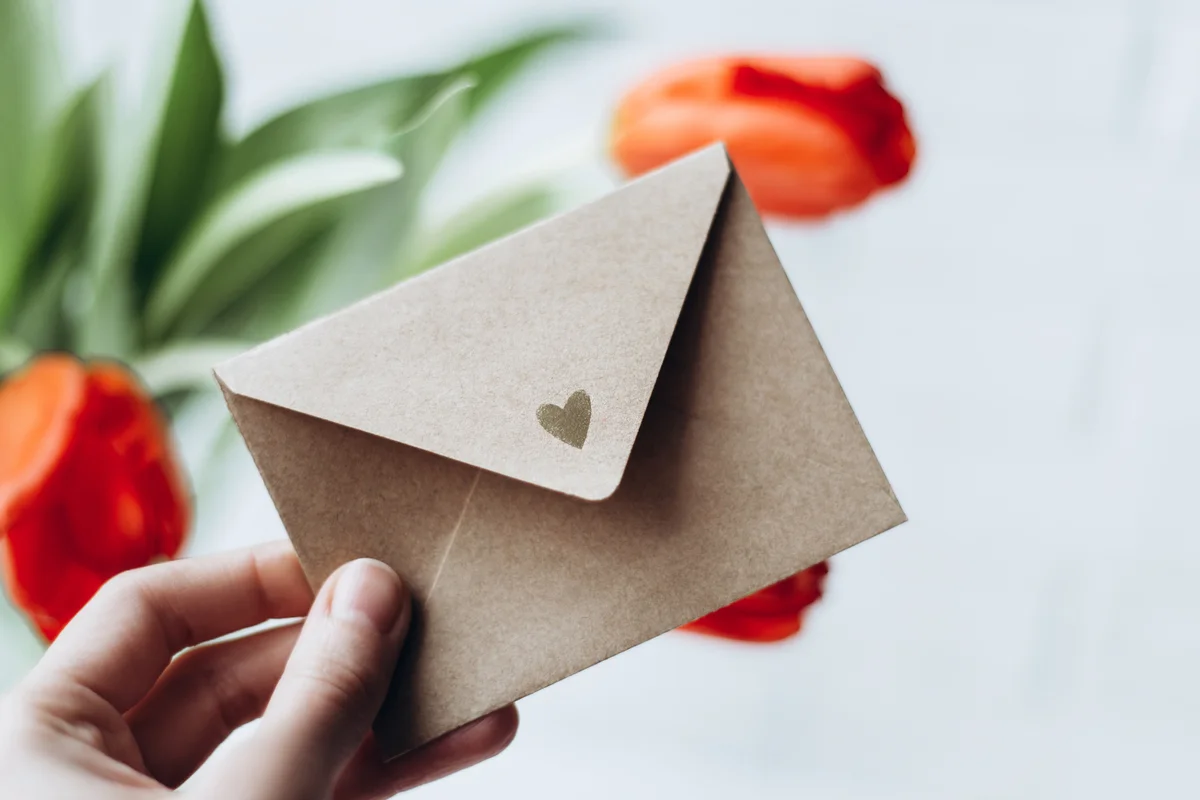hand holding a wedding card