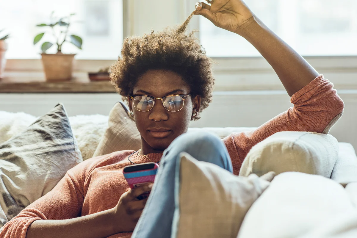 Young woman using smart phone at home