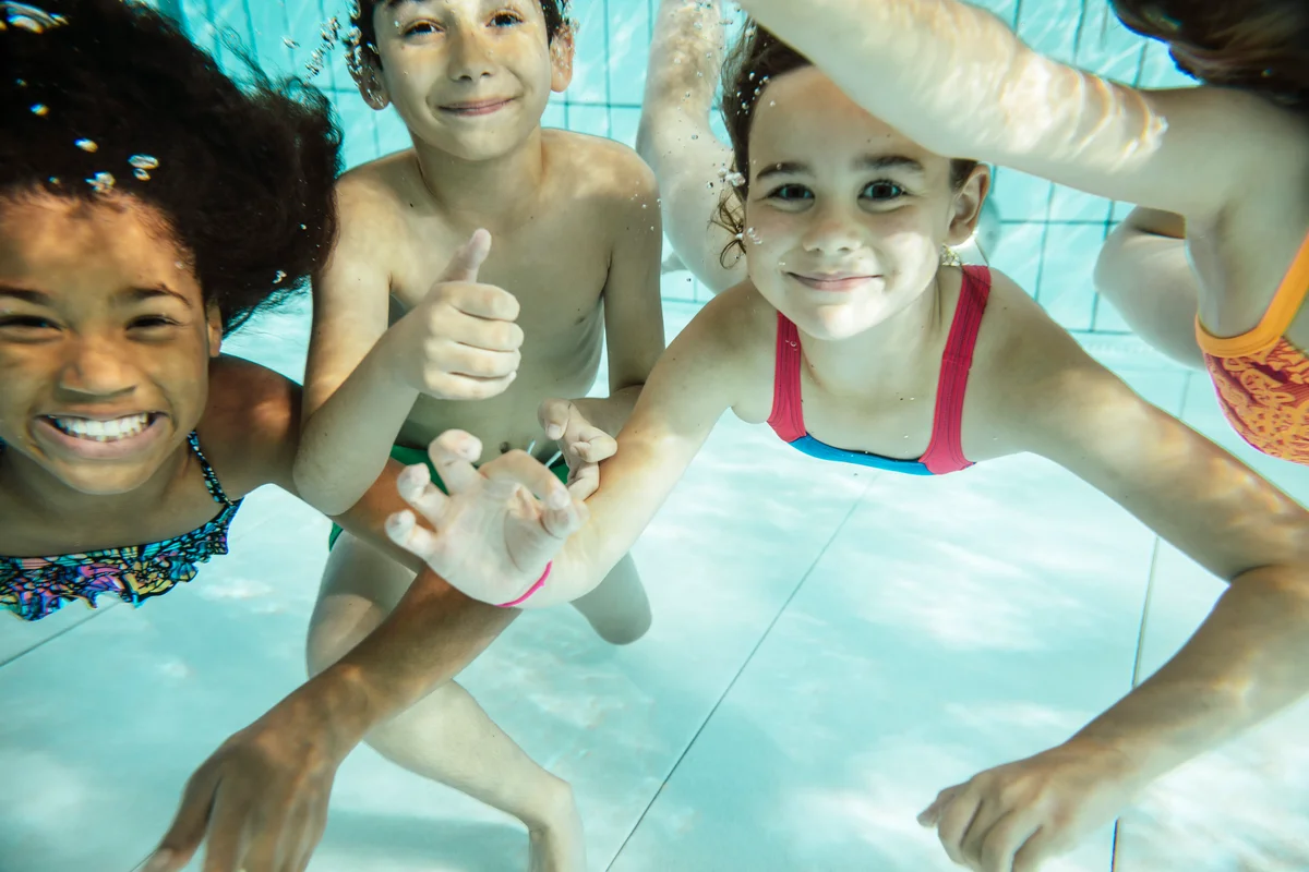 children in pool underwater