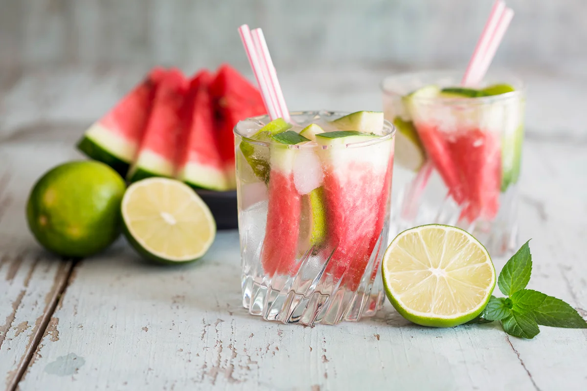 Fresh mineral water with watermelon, lime and ice in glasses