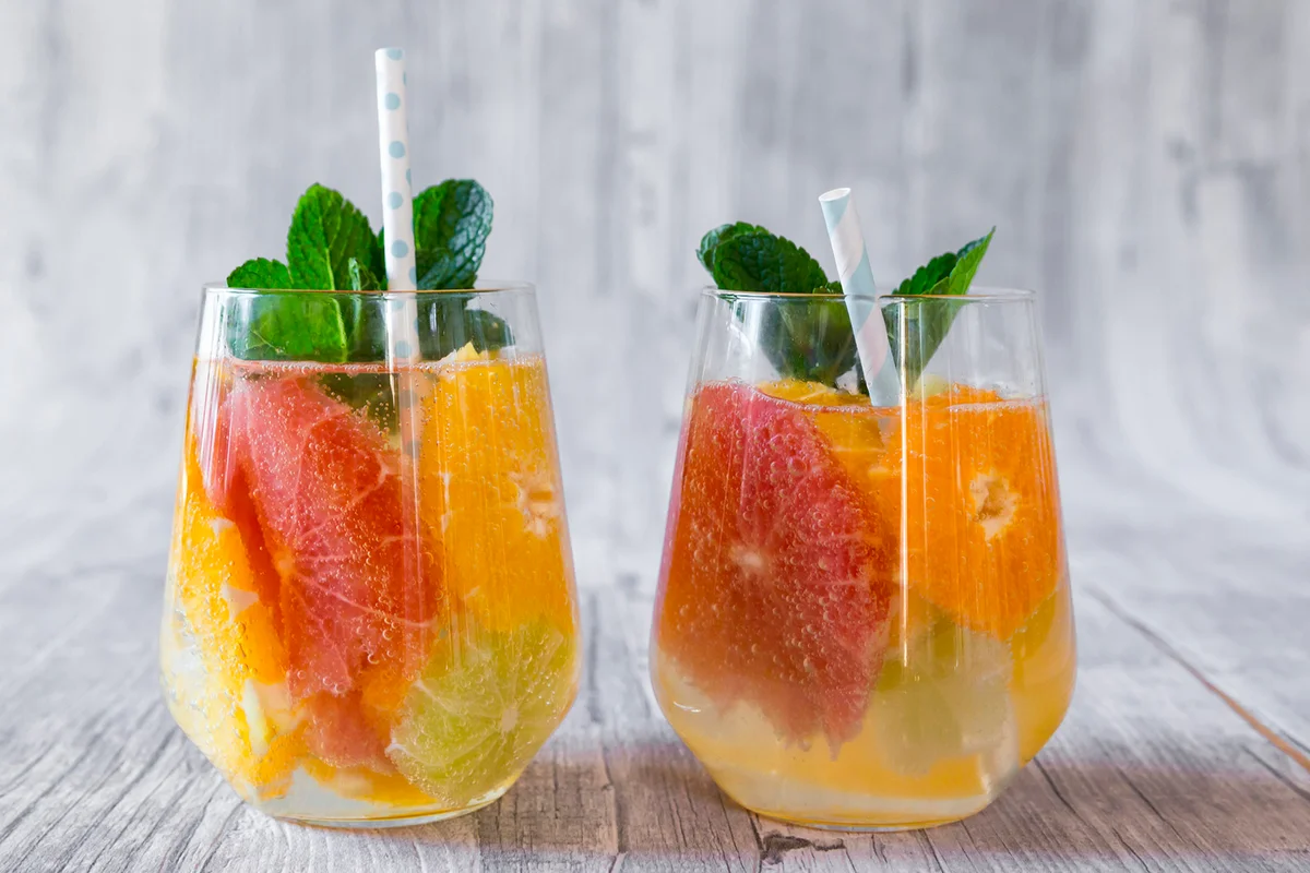 Two glasses of detox water infused with citrus fruits