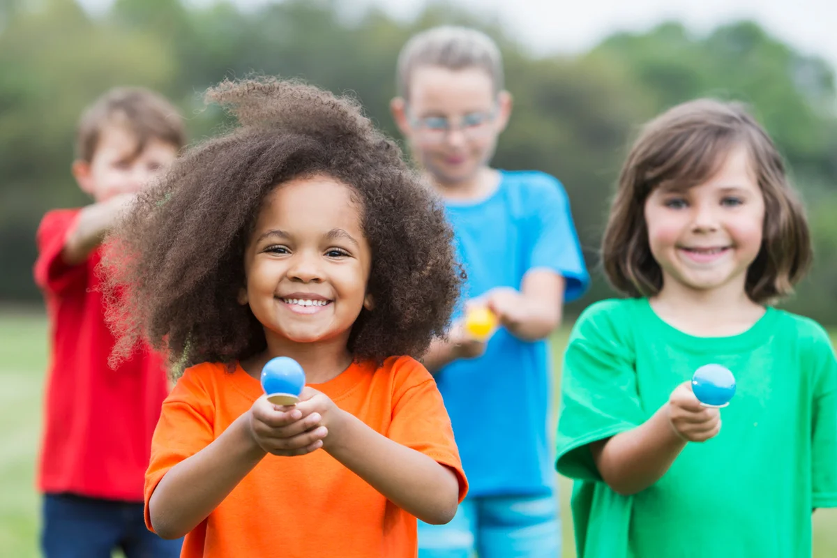 group of children in an egg spoon race