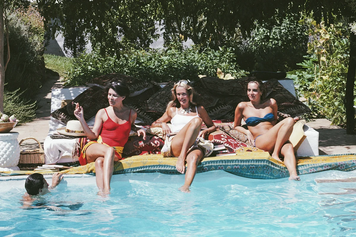 A group of friends relax by a private pool in Benahavis