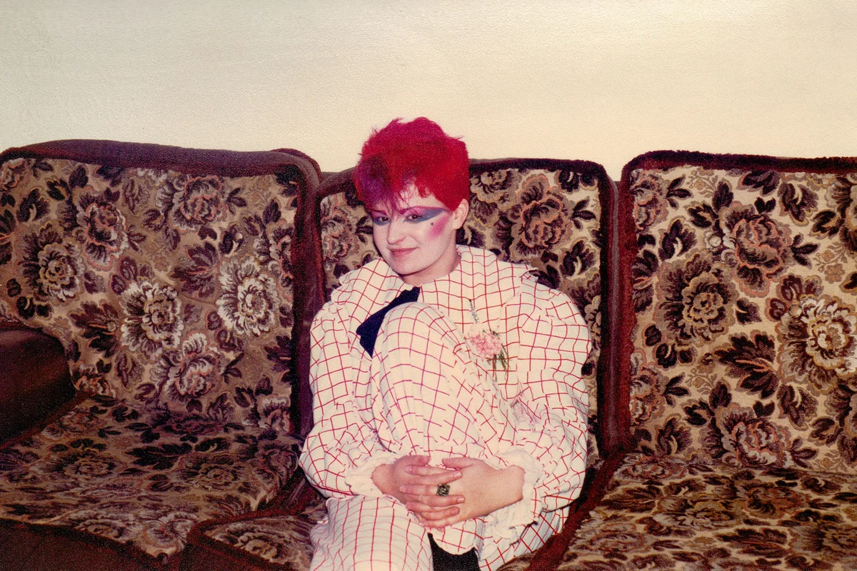 Young woman wearing white and red plaid jumpsuit