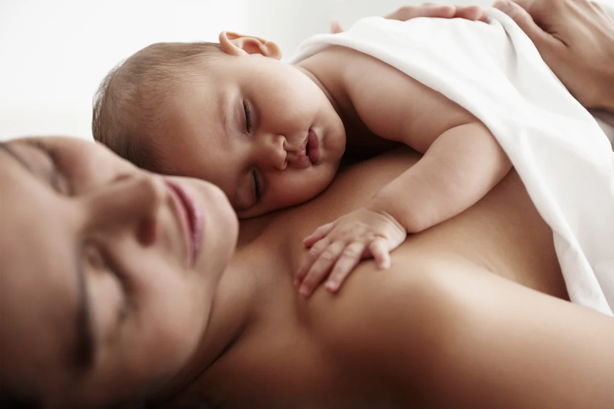 Infant Daughter Sleeping On Mother's Chest