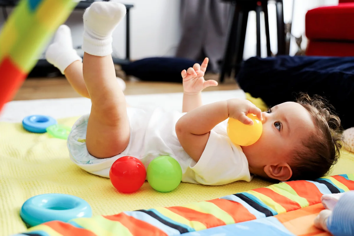 Baby girl plays with toys