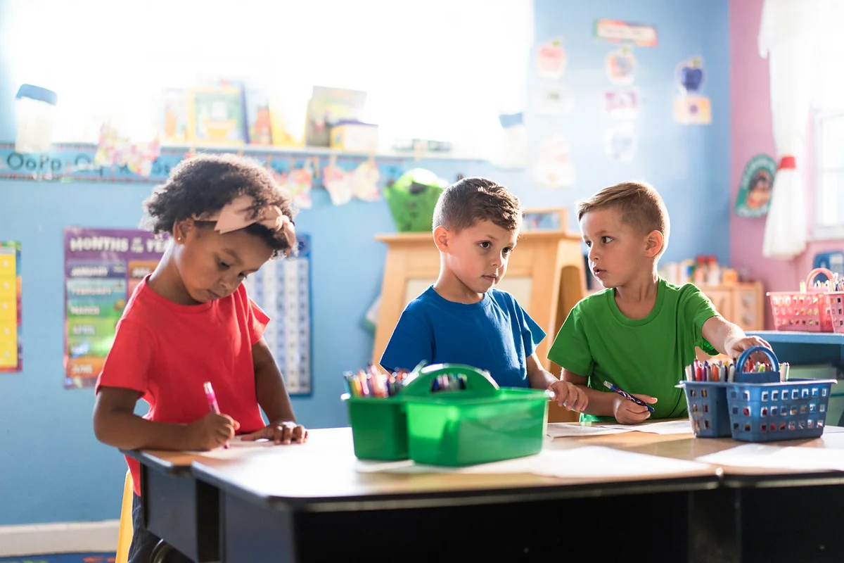 Three kids actively learning and playing in a nurturing daycare environment