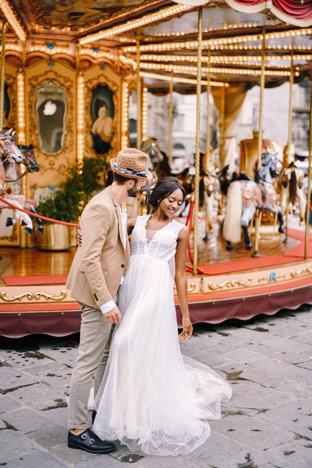 Wedding couple near carousel