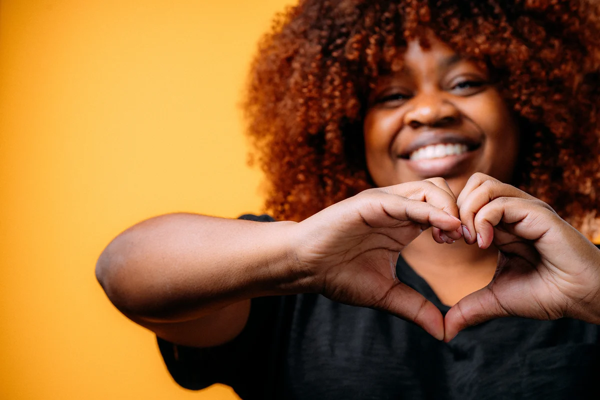 woman making heart hands