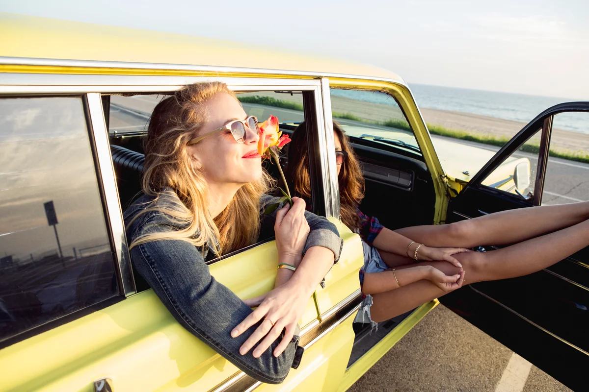 two women in a car at the beach