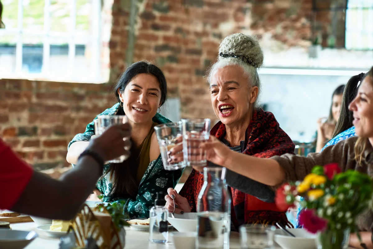 women toasting with water in a restaurant
