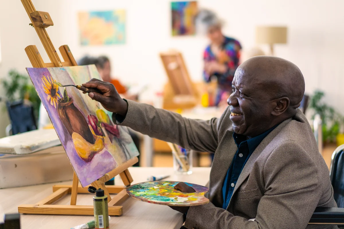 man painting in nursing home