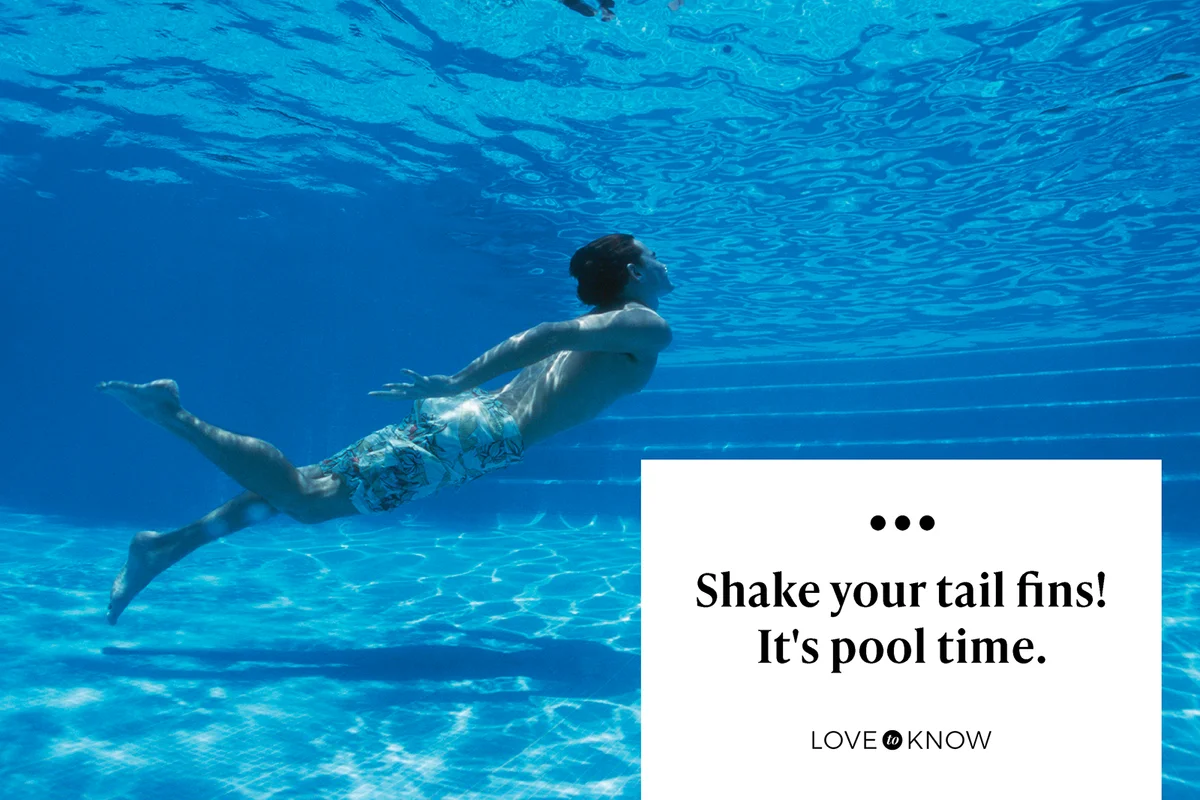 Young man swimming underwater in pool