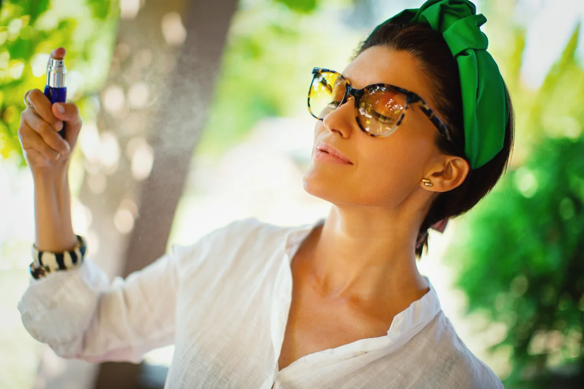 woman spritzing perfume