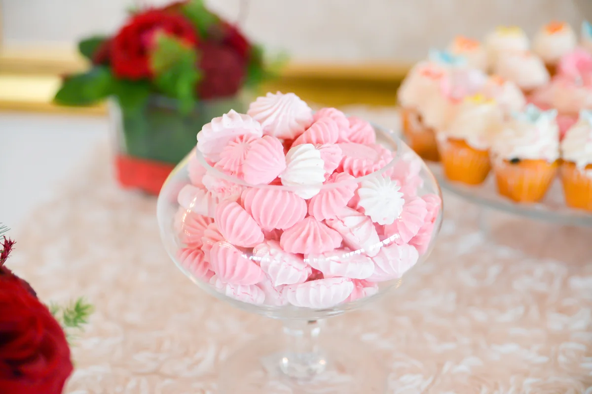 Delicious meringue cookies arranged on the table for wedding reception