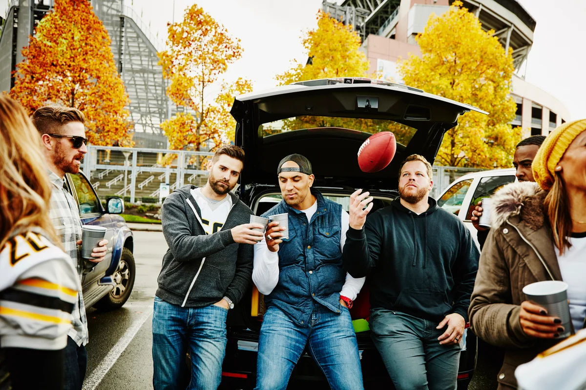 Friends toasting at tailgating party before game