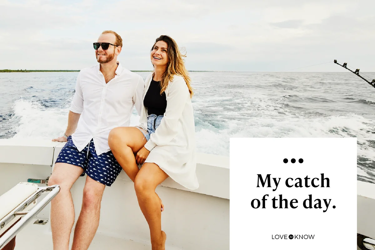 Wide shot of smiling couple sitting on stern of sport fishing boat