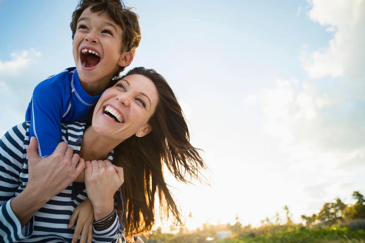 Woman with son playing at beach