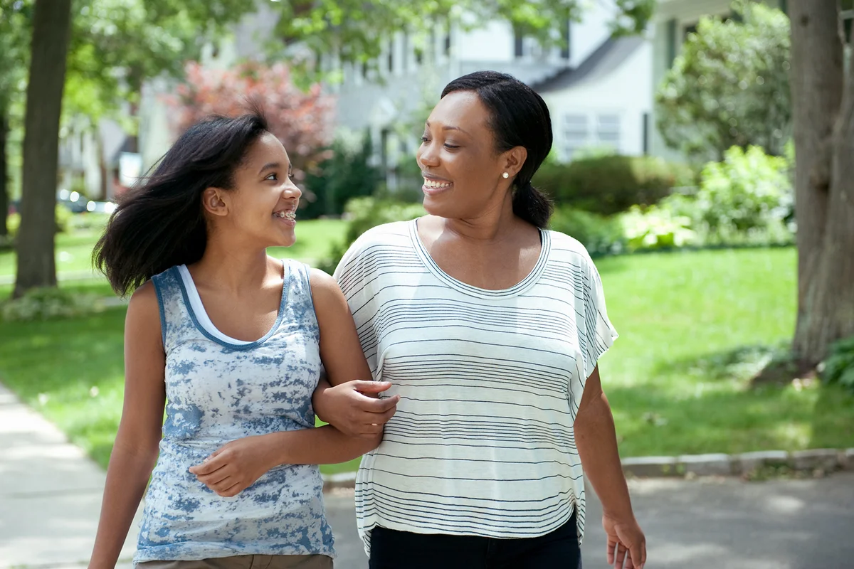Mom and Daughter walking together in neighborhood