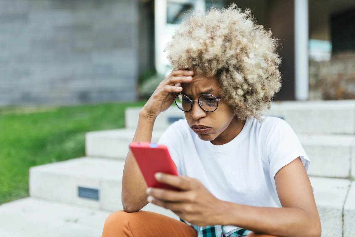 frustrated woman looking at phone