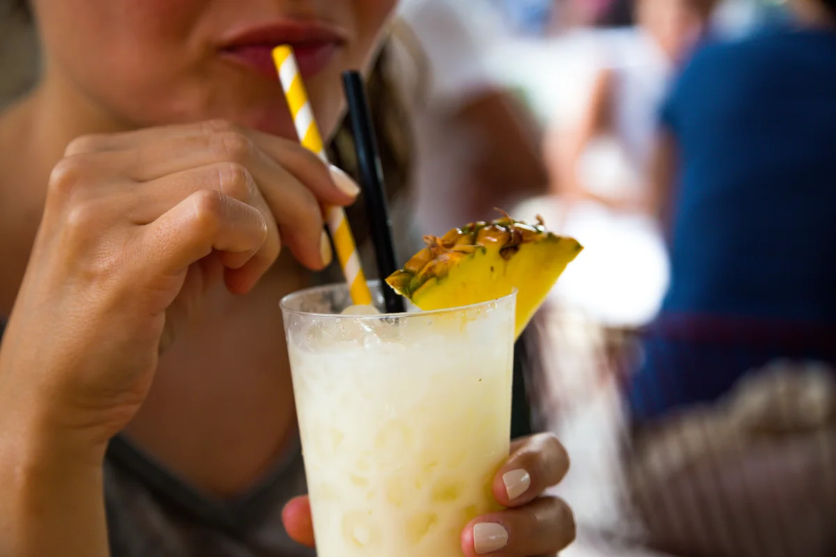 woman drinking pina colada