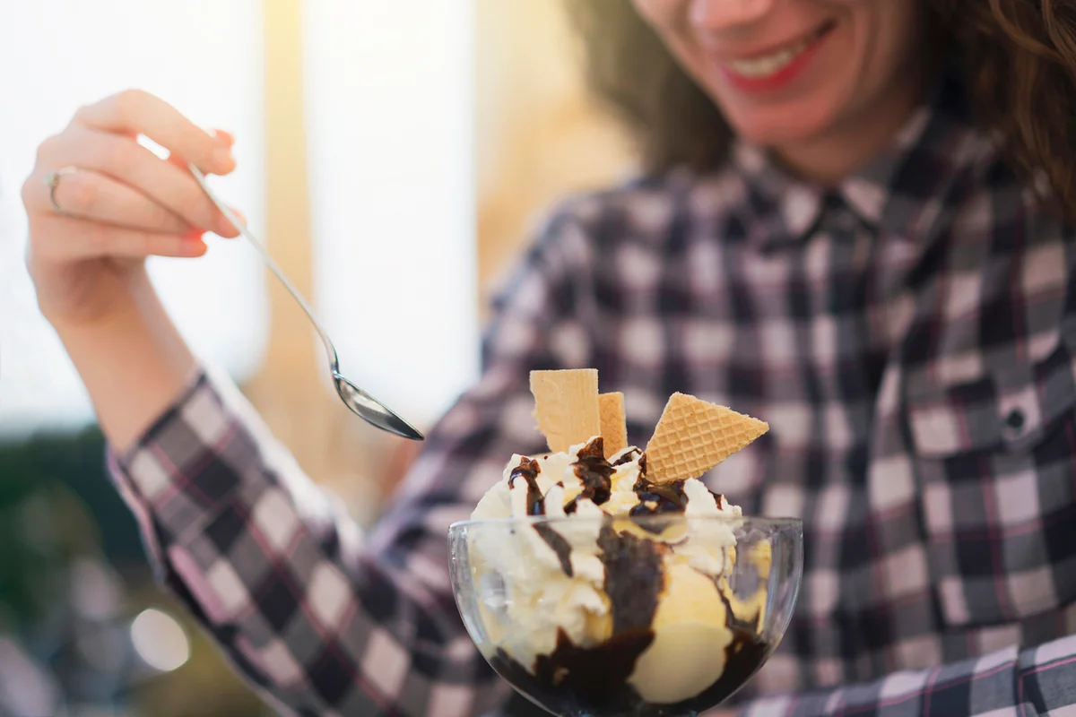 Smiling woman eating ice cream