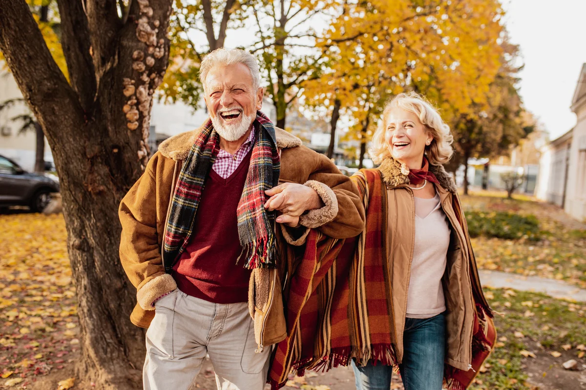 laughing couple outdoors in the fall