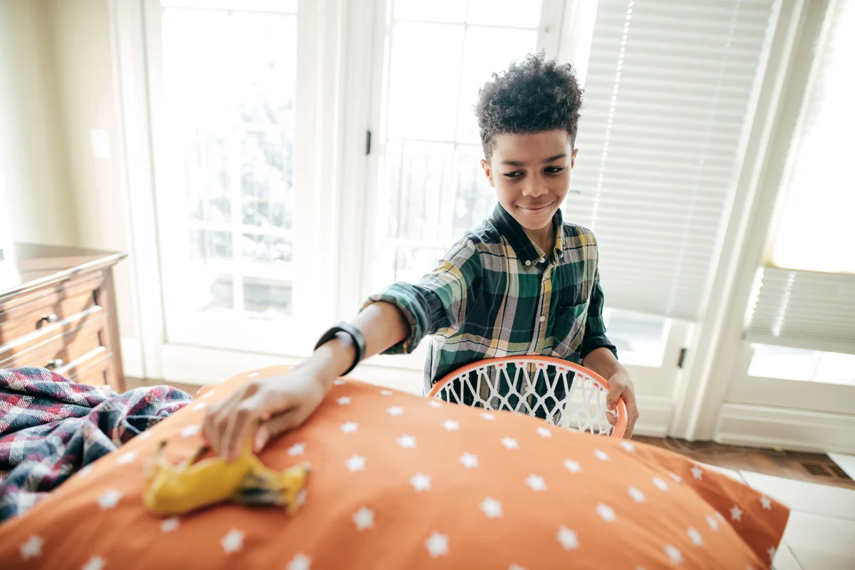 Boy cleaning his bedroom