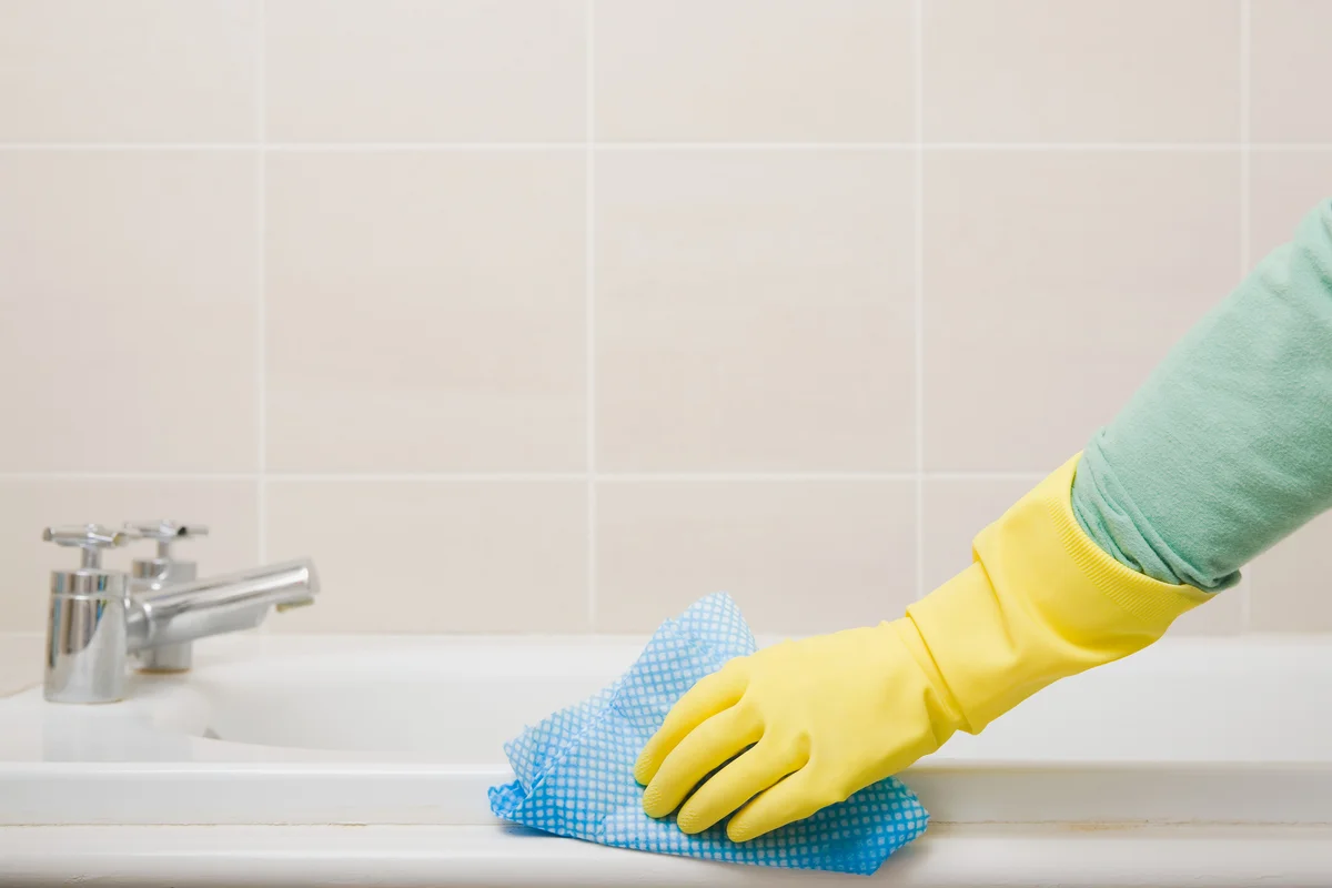 wiping down the bath tub