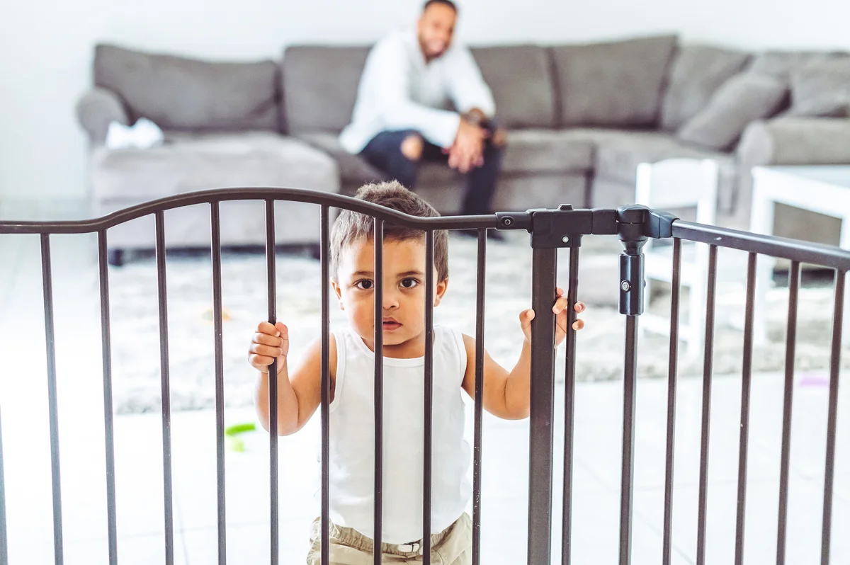 boy behind baby gate