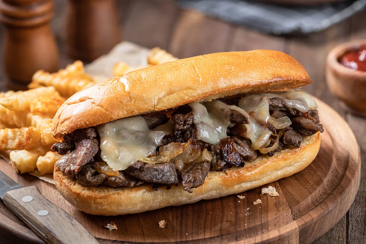 Philly cheesesteak sandwich and french fries