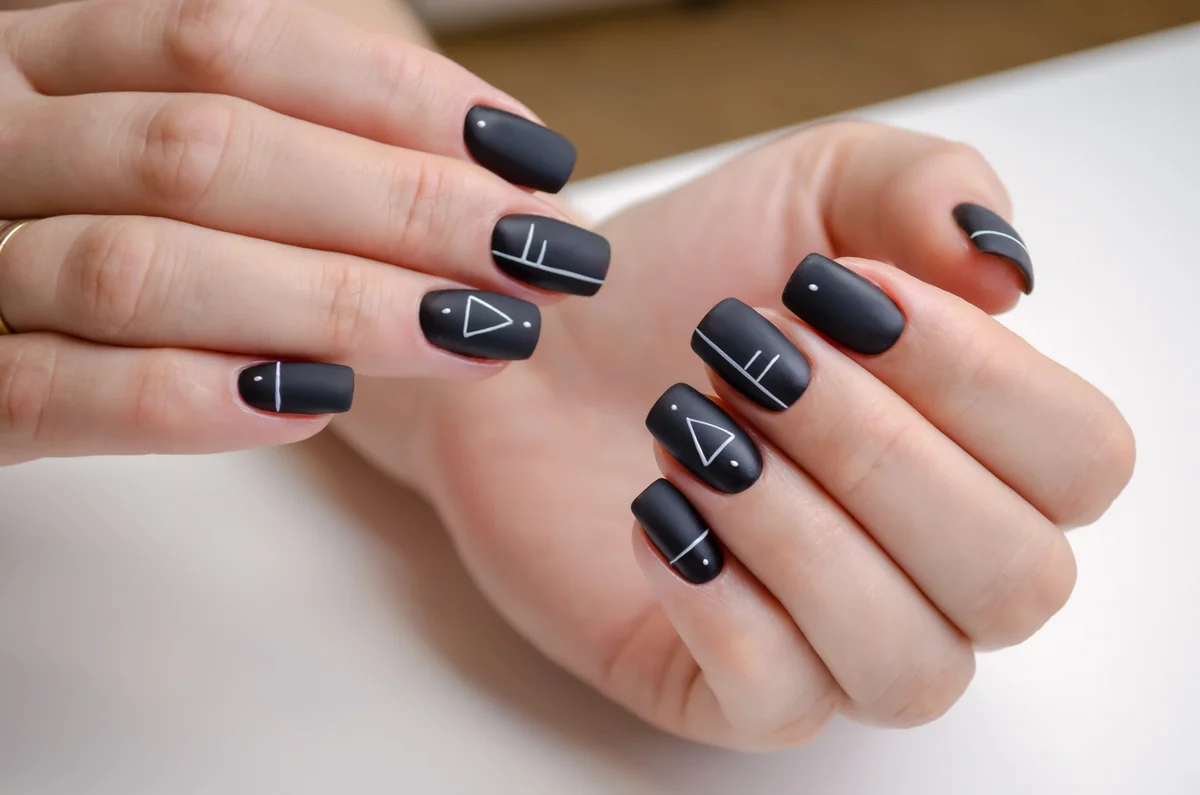 woman with a black matte gel polish and geometric design