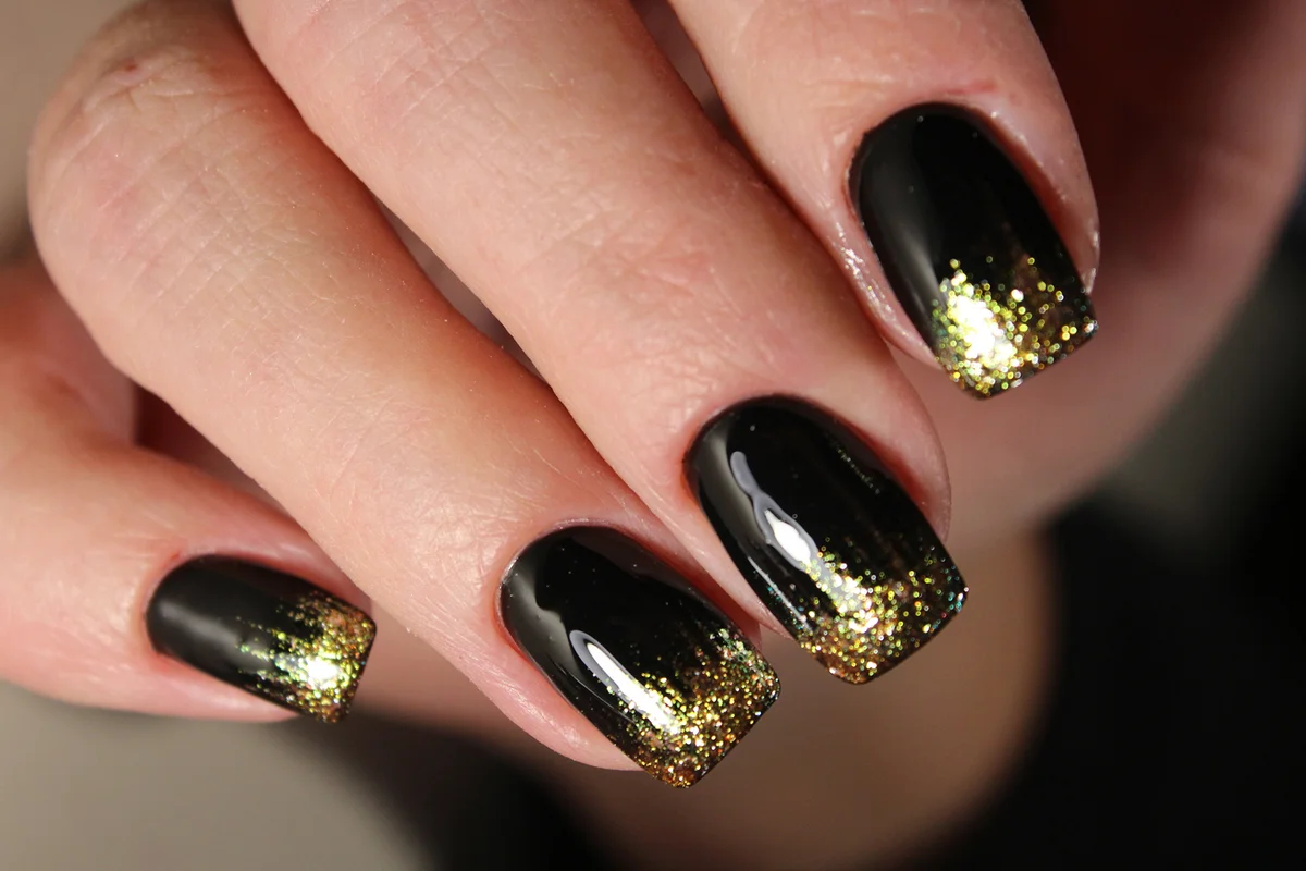 Evening manicure design in black and gold color