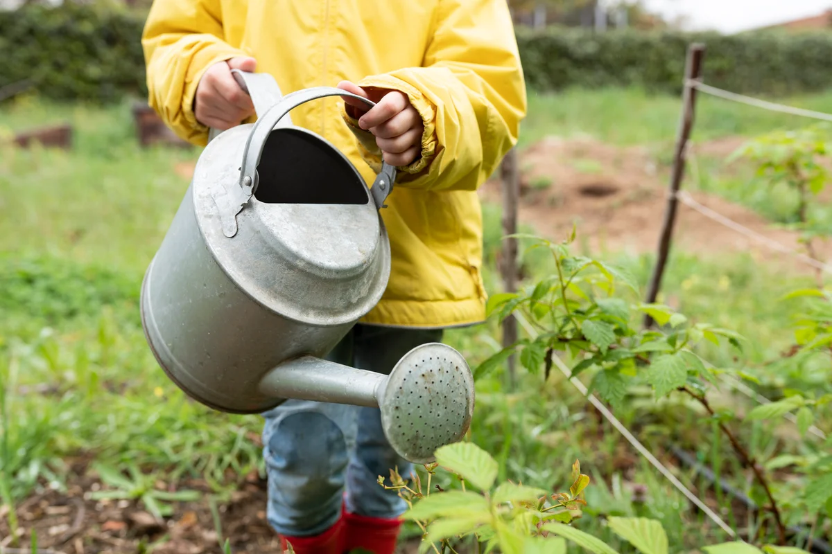 child with a watering can