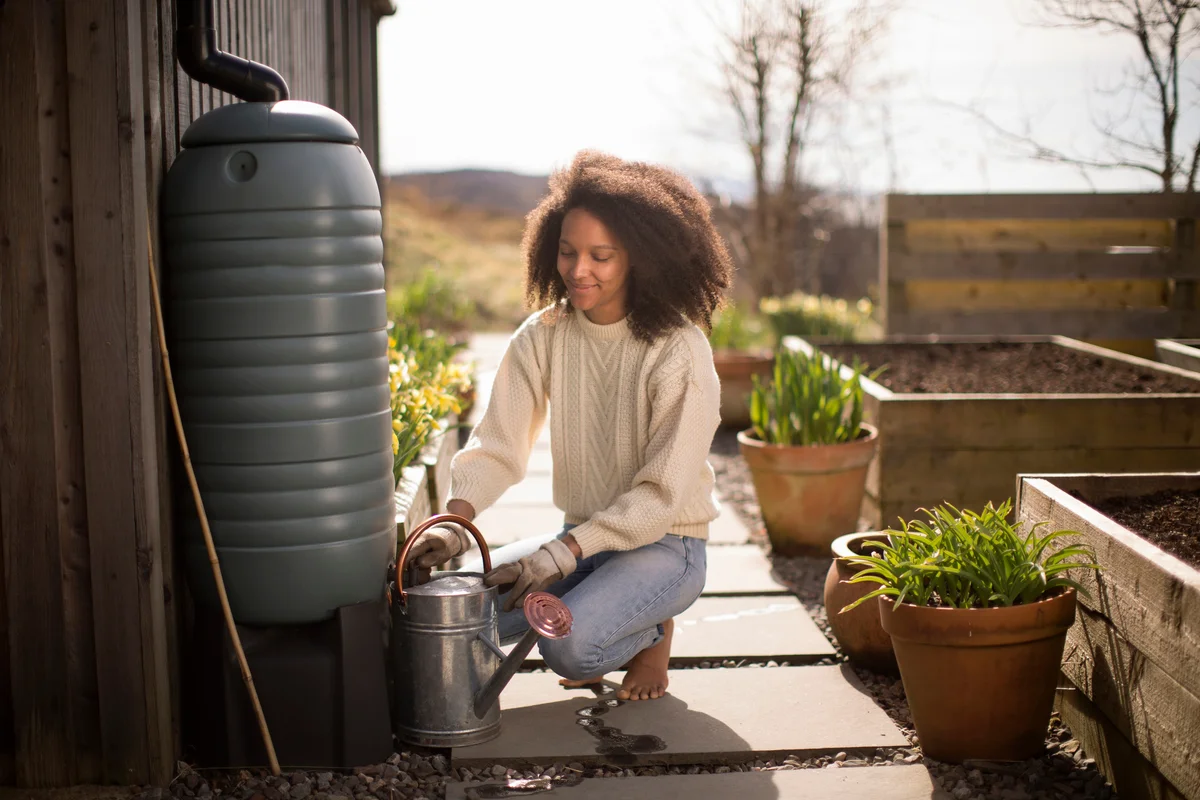 woman filling watering can