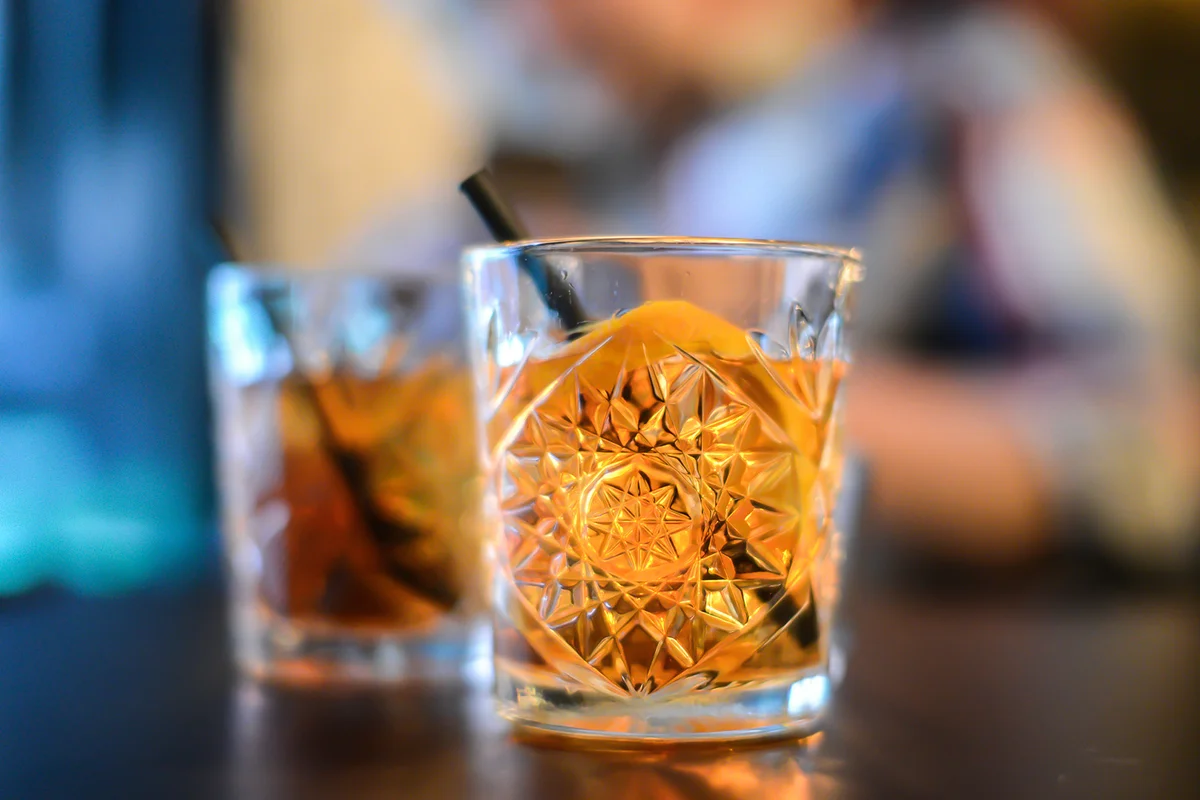 Two old fashioned cocktails on a table