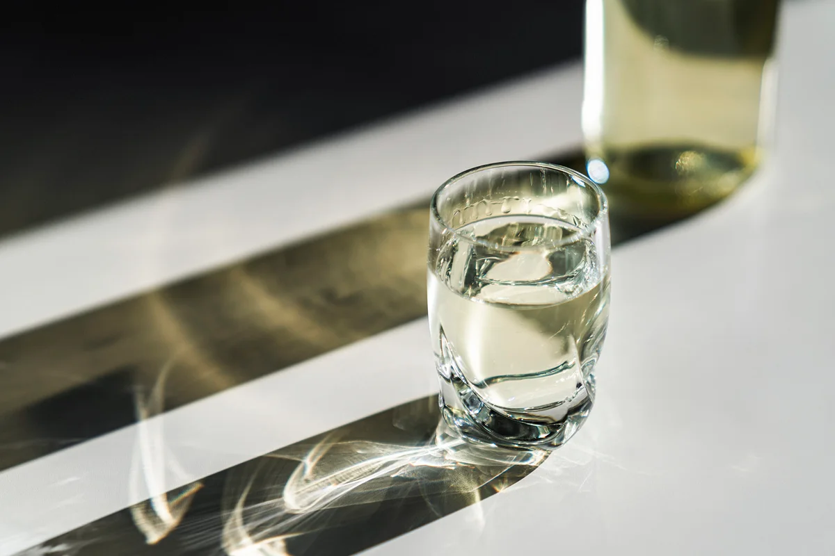 Glass and bottle with hard liquor