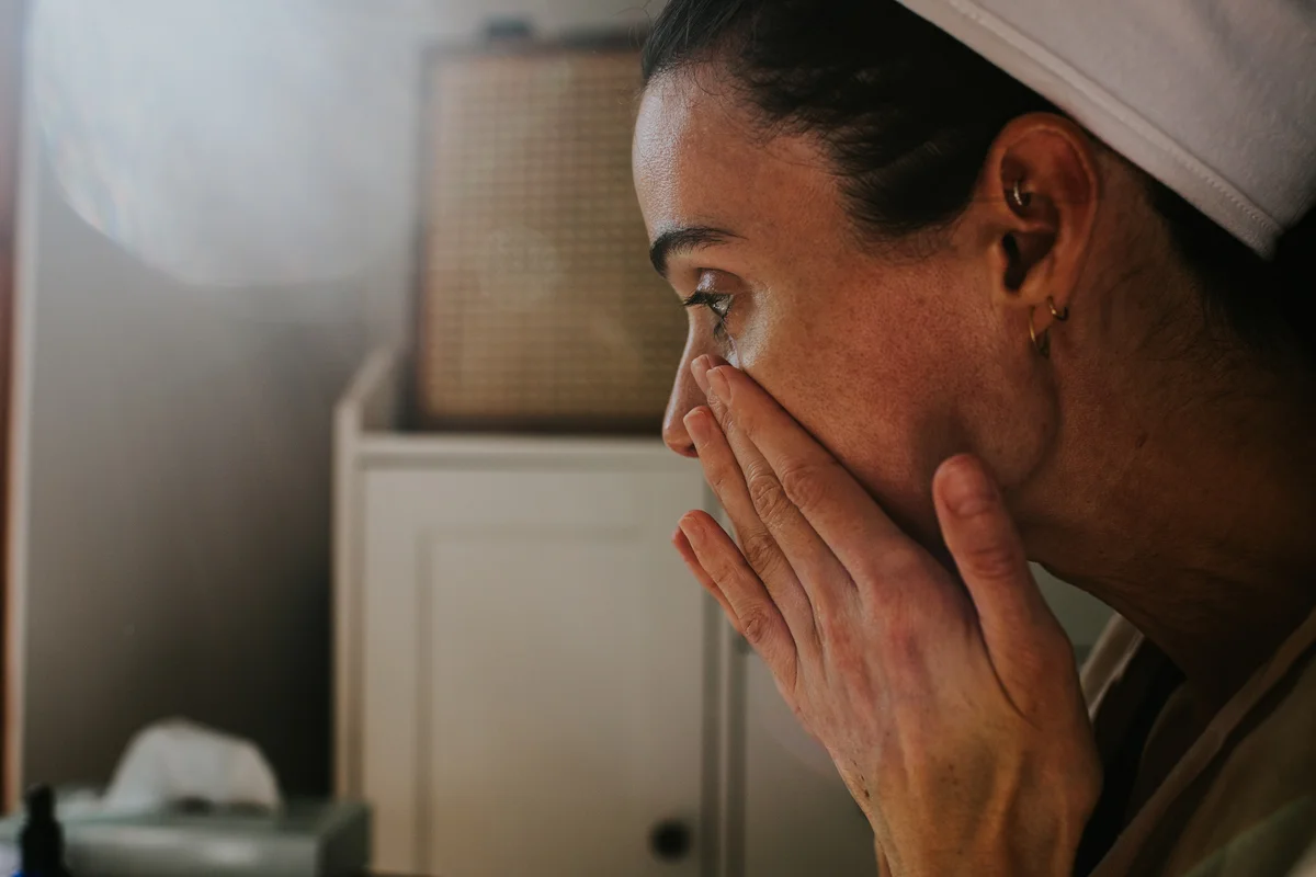 woman patting in facial serum