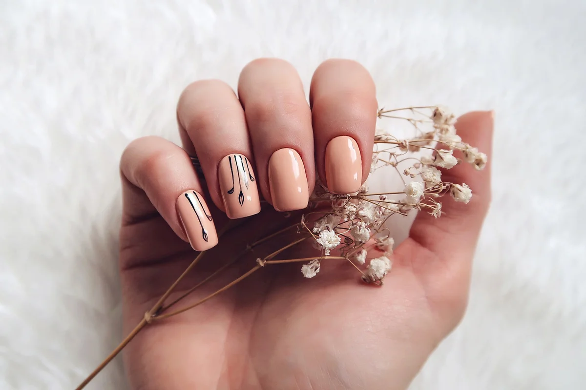 Woman with nail art holding flower
