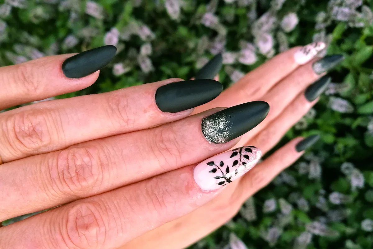 Woman Fingers With Nail Art Manicure In Black And Pink Colour