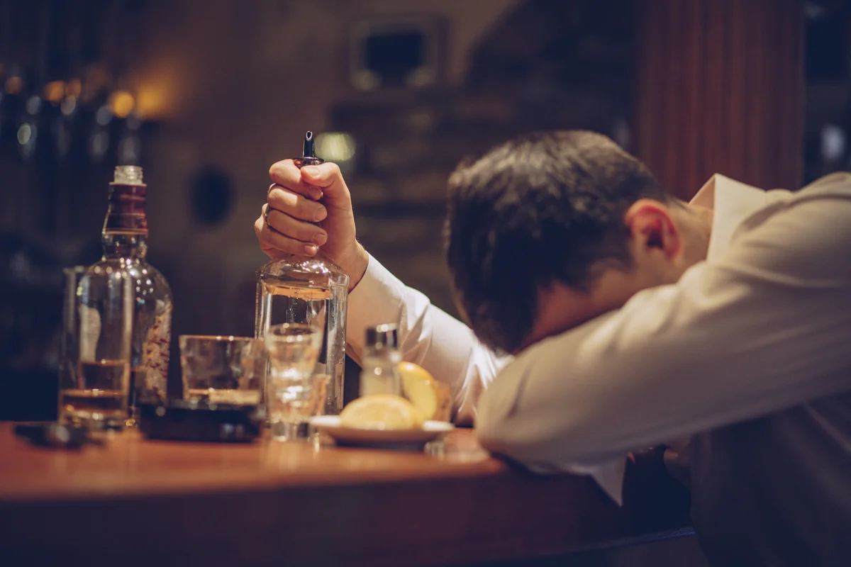 man with head on bar