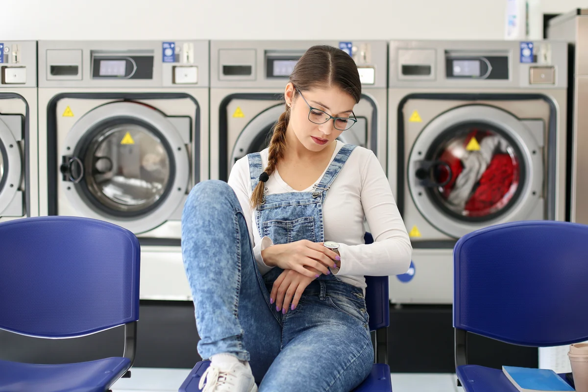 woman waiting at laundromat