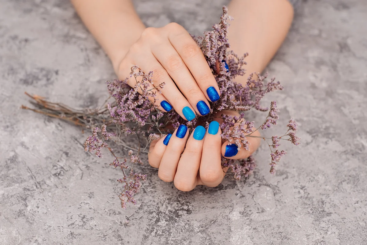 Female hands with blue nails
