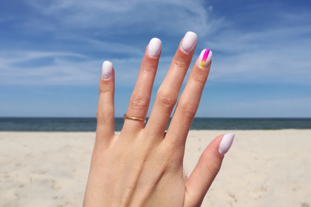 Woman Fingers With Nail Art Manicure In White Colour